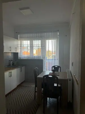 a kitchen and dining room with a table and chairs at Apartman Iris in Bosanski Brod
