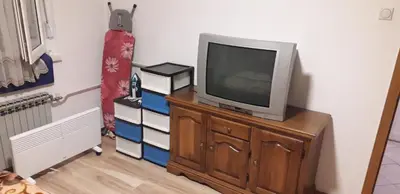 a television sitting on a dresser in a room at Apartman Iris in Bosanski Brod