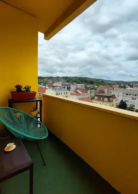 a balcony with a bench and a view of a city at Sunflower Apartment in Banja Luka