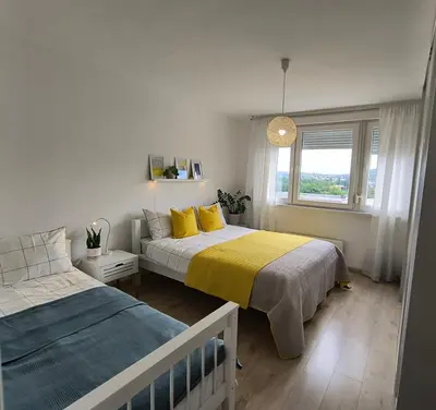 a bedroom with two beds and a window at Sunflower Apartment in Banja Luka
