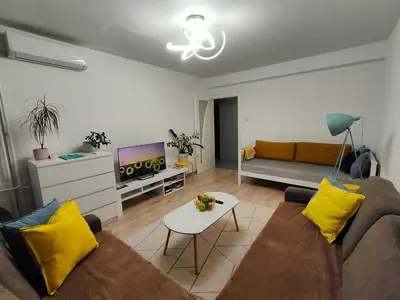 a living room with a couch and a tv at Sunflower Apartment in Banja Luka