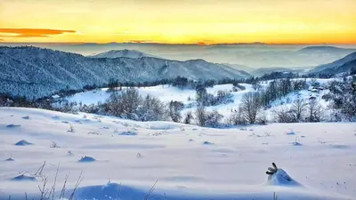 a snow covered mountain with a sunset in the background at Naša Maša Doboj- bungalov Nasa Masa Doboj-bungalov in Doboj