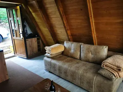 a brown couch sitting in a living room at Naša Maša Doboj- bungalov Nasa Masa Doboj-bungalov in Doboj
