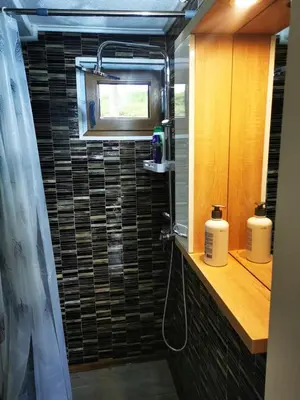 a bathroom with a shower with a sink and a mirror at Naša Maša Doboj- bungalov Nasa Masa Doboj-bungalov in Doboj