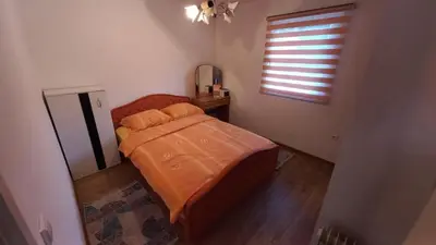 a small bedroom with a bed and a window at Majestic House in Ivišovo Greblje