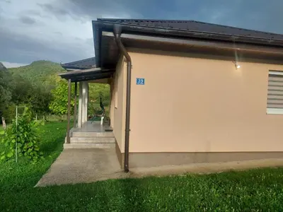 a small building with a sign on the side at Majestic House in Ivišovo Greblje