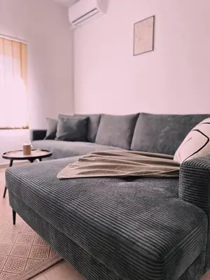 a living room with a couch and a table at Layal Home in Bihać