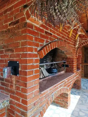 a brick oven with a pot in it at Ranč Kuzmanović in Doboj