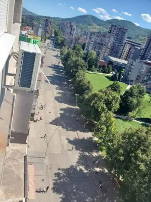 an empty street in a city with buildings and trees at StaraCarsija- Zenica, City Center in Zenica