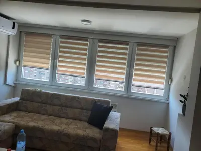 a living room with a couch and windows with blinds at StaraCarsija- Zenica, City Center in Zenica