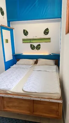 two twin beds in a room with a blue ceiling at Retro II