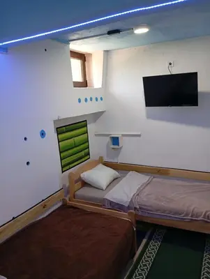 a bedroom with a bed and a flat screen tv at Retro II