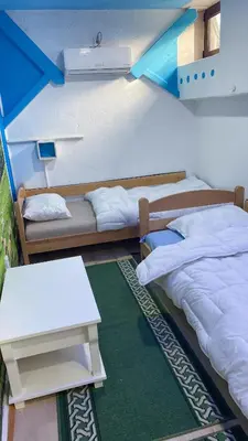 a room with two beds and a table and a couch at Retro II