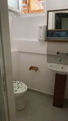 a bathroom with a toilet and a sink at Retro II