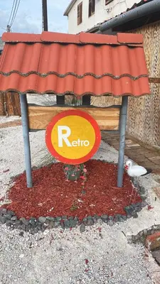 a red roof on top of a sign on the street at Retro II