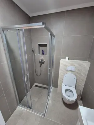 a bathroom with a shower and a toilet at Apartman Belvedere Lux, Doboj in Doboj