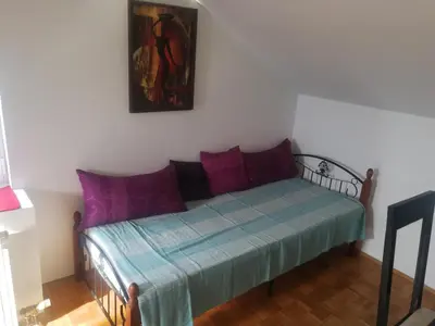 a bedroom with a bed with purple and blue at Apartment Nedic in Doboj