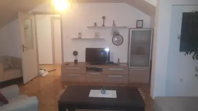 a living room with a tv and a coffee table at Apartment Nedic in Doboj