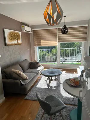 a living room with a couch and a table at CENTRAL POINT APARTMENT - City centar Zenica- in Zenica