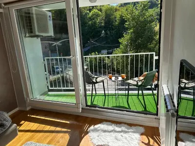 a balcony with a view of a table and chairs at CENTRAL POINT APARTMENT - City centar Zenica- in Zenica