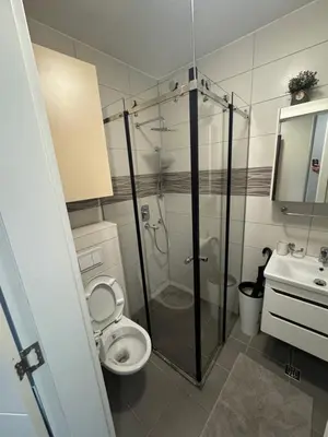 a bathroom with a shower and a toilet and a sink at CENTRAL POINT APARTMENT - City centar Zenica- in Zenica