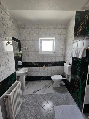 a bathroom with a toilet and a sink at Rooms MIG in Banja Luka