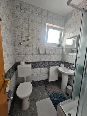 a bathroom with a toilet and a sink at Rooms MIG in Banja Luka