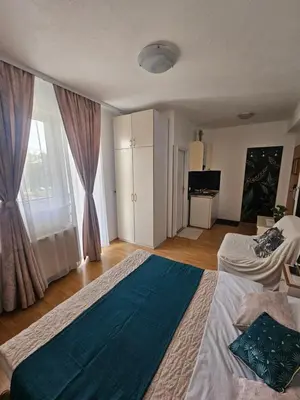 a bedroom with a large bed and a window at Rooms MIG in Banja Luka