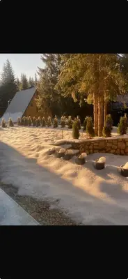 a snow covered yard with trees and a building at Vila Beganovic in Šišava