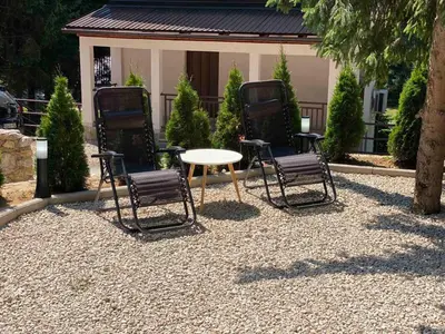 a group of chairs and a table in a yard at Vila Beganovic in Šišava