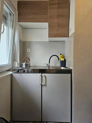 a kitchen with a sink and a counter top at Apartmani S Banja Luka in Pištelići