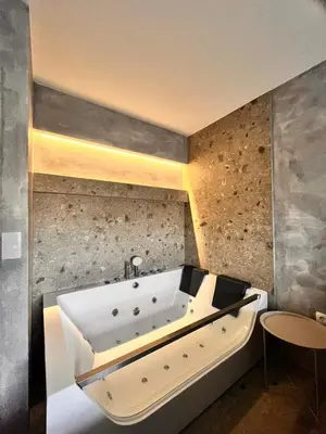 a large white bath tub in a room at Relax Apartman DMBL in Banja Luka