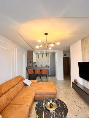 a living room with a couch and a table at Relax Apartman DMBL in Banja Luka