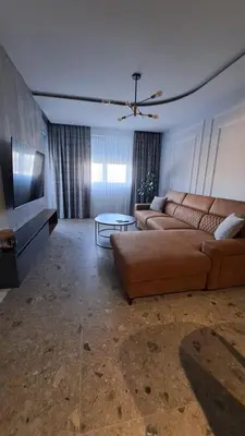 a living room with a couch and a table at Relax Apartman DMBL in Banja Luka