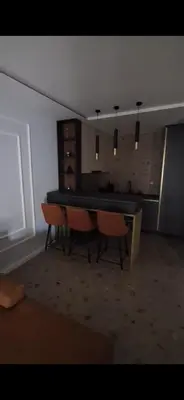 a dining room with a table and chairs in a room at Relax Apartman DMBL in Banja Luka