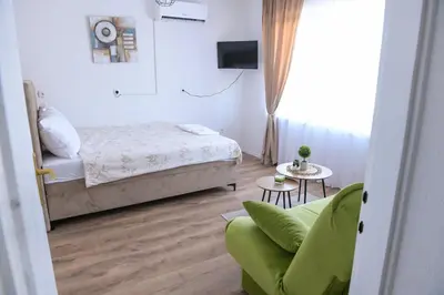 a small bedroom with a bed and a couch at Stan na dan-Studio 10 centar Gradiška in Bosanska Gradiška