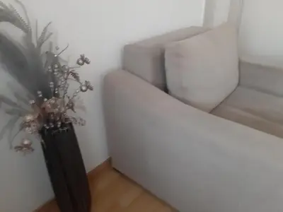 a living room with a white couch and a plant at CenterZeroZoneOne in Banja Luka