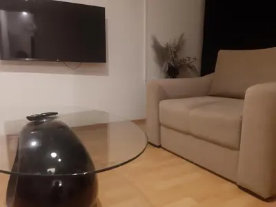 a living room with a glass table and a couch at CenterZeroZoneOne in Banja Luka