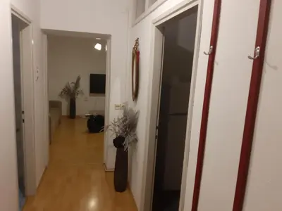 a hallway with a door leading to a living room at CenterZeroZoneOne in Banja Luka