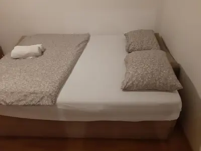 a bed with two pillows on top of it at CenterZeroZoneOne in Banja Luka