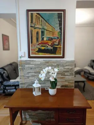 a coffee table in a living room with a painting on the wall at Apartman Centar in Banja Luka