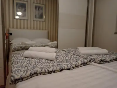 two beds with towels sitting on top of them at Apartman Centar in Banja Luka