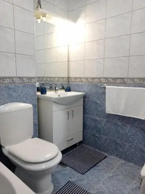 a bathroom with a white toilet and a sink at Apartman Centar in Banja Luka
