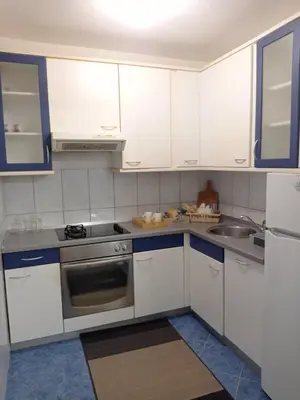 a kitchen with white cabinets and a sink at Apartman Centar in Banja Luka