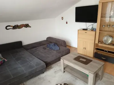 a living room with a couch and a tv at CentarTuzla in Tuzla