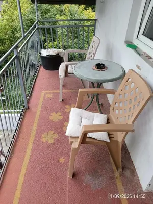 a patio with two chairs and a table on a balcony at CentarTuzla in Tuzla