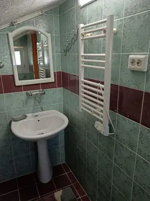 a bathroom with a sink and a mirror at CentarTuzla in Tuzla