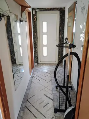 a hallway with a treadmill in front of a door at CentarTuzla in Tuzla