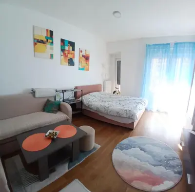 a living room with a couch and a bed at iwe in Banja Luka