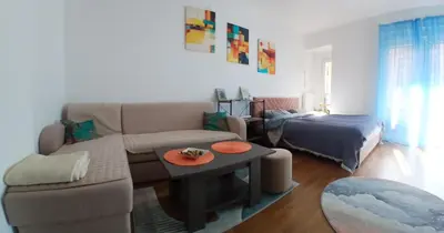 a living room with a couch and a bed at iwe in Banja Luka